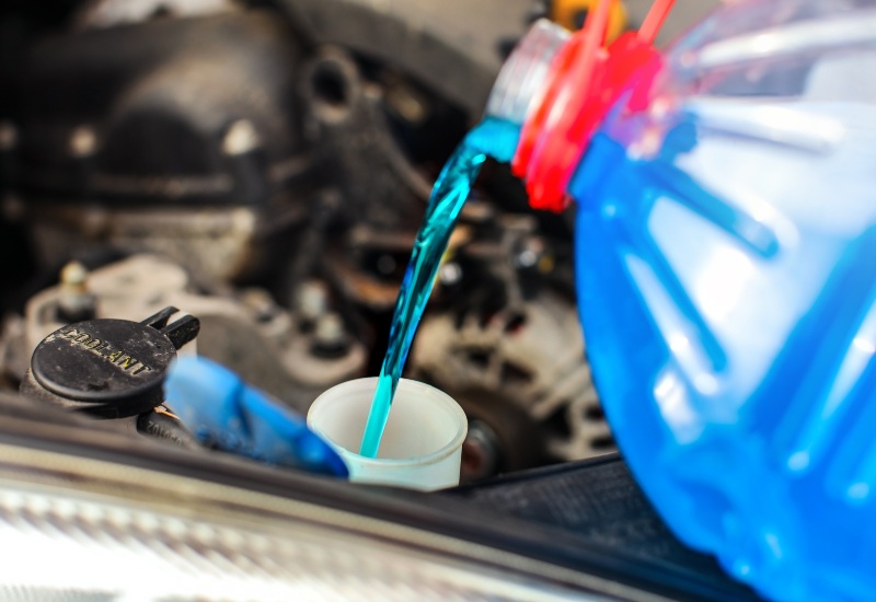 Adding antifreeze coolant, an important car fluid, into a vehicle in Texas & Arkansas